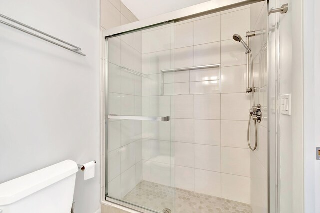 bathroom with toilet and walk in shower