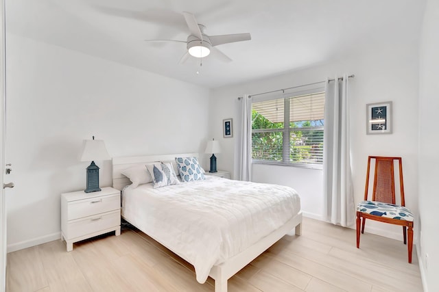 bedroom with ceiling fan and light hardwood / wood-style flooring