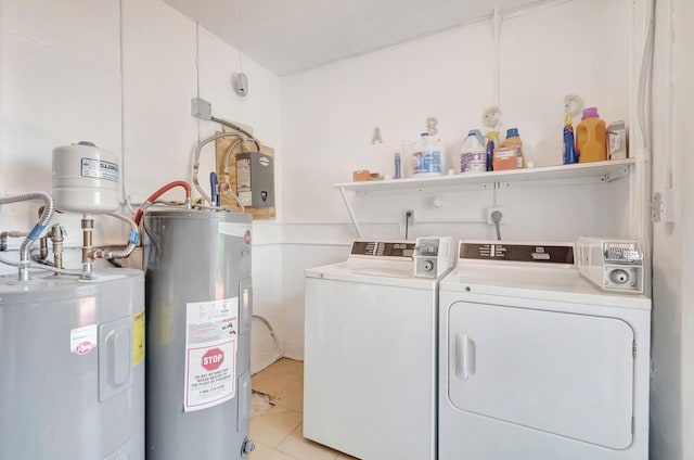 laundry area featuring light tile patterned floors, washing machine and dryer, a textured ceiling, and water heater