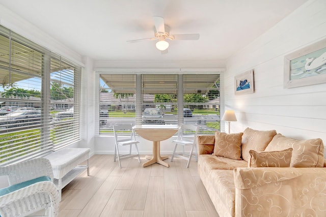 sunroom featuring ceiling fan