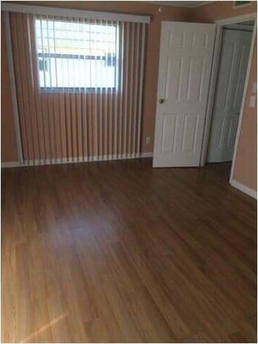 unfurnished bedroom with dark hardwood / wood-style flooring