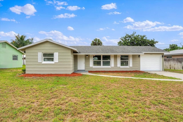 ranch-style house featuring a garage and a front yard