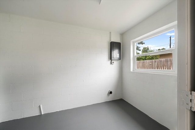 spare room with electric panel and concrete flooring