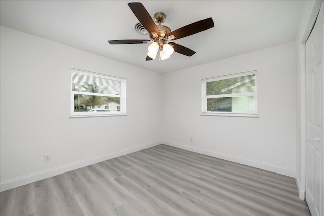 unfurnished room with plenty of natural light, light hardwood / wood-style floors, and ceiling fan