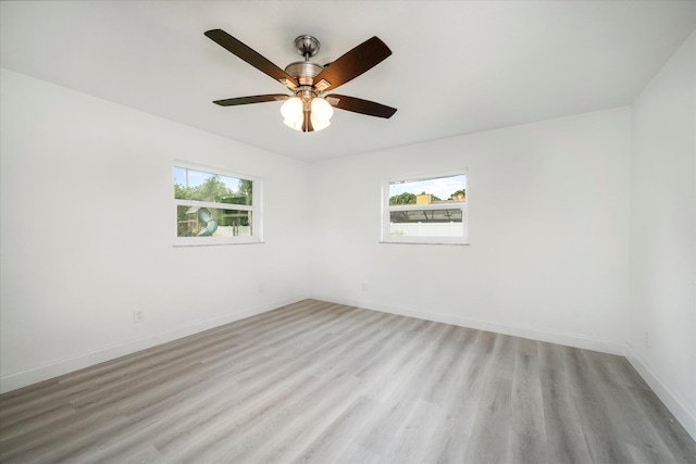 unfurnished room with plenty of natural light, ceiling fan, and light wood-type flooring