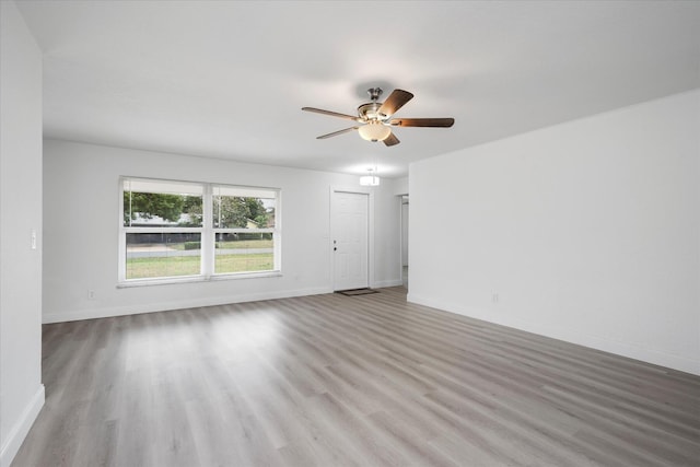 spare room featuring light hardwood / wood-style floors and ceiling fan