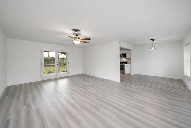 unfurnished living room featuring french doors, light wood-type flooring, and ceiling fan