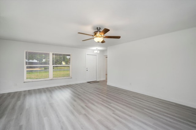 spare room featuring ceiling fan and light hardwood / wood-style floors