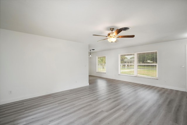 unfurnished room featuring ceiling fan, a healthy amount of sunlight, and light wood-type flooring