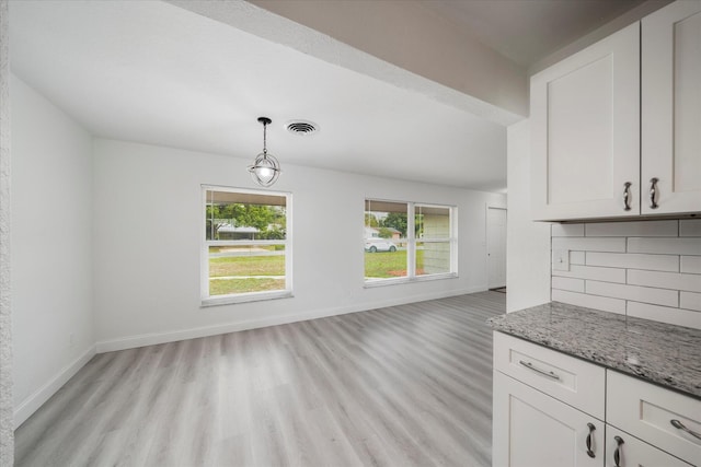 unfurnished dining area with light hardwood / wood-style flooring