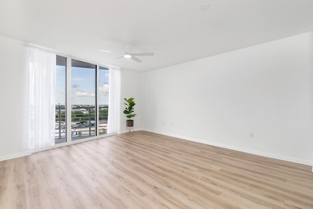 unfurnished room featuring ceiling fan and light hardwood / wood-style flooring