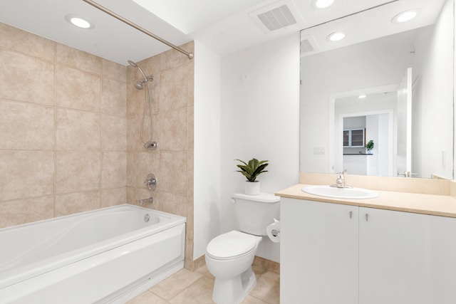 full bathroom featuring tile patterned flooring, vanity, toilet, and tiled shower / bath