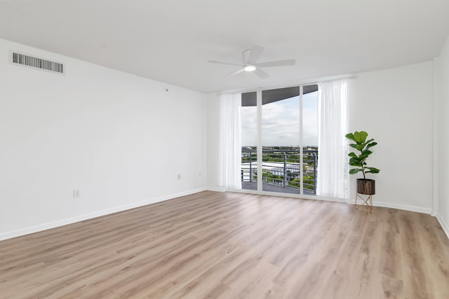 spare room featuring ceiling fan and light hardwood / wood-style flooring