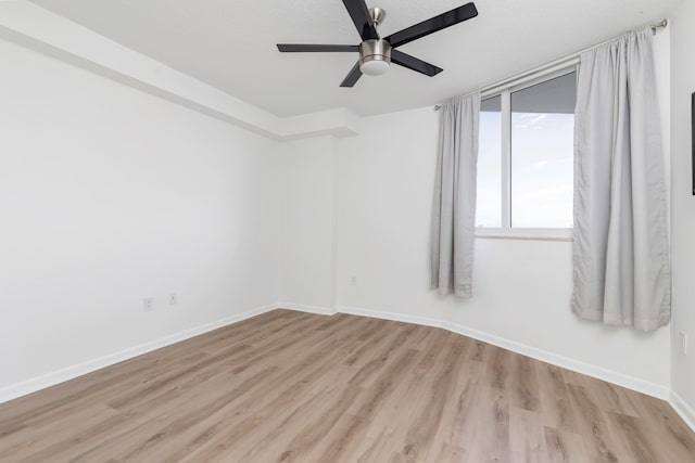 spare room featuring ceiling fan, light hardwood / wood-style floors, and a textured ceiling