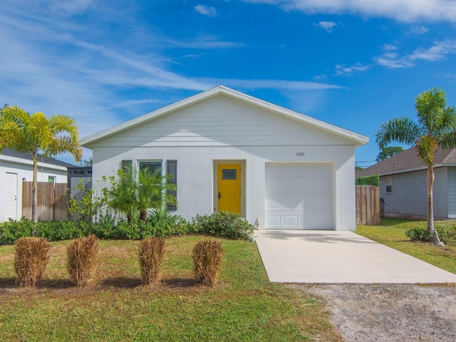 ranch-style house featuring a garage and a front yard