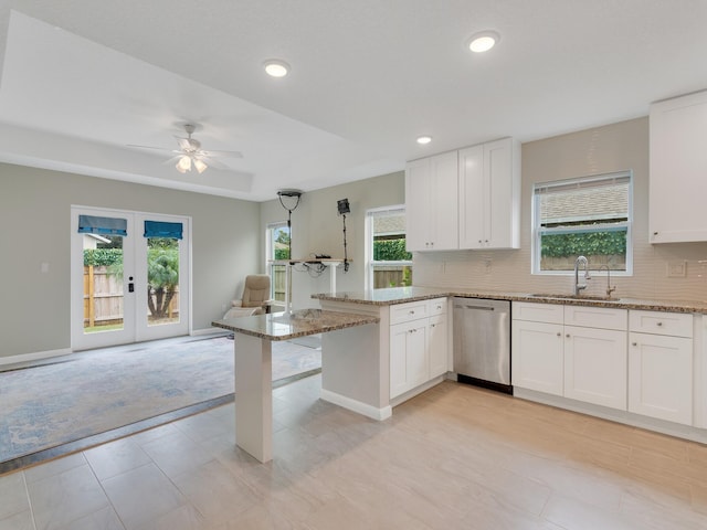 kitchen with dishwasher, white cabinetry, and plenty of natural light