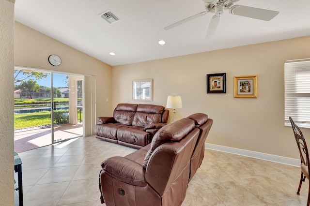 tiled living room with plenty of natural light, lofted ceiling, and ceiling fan