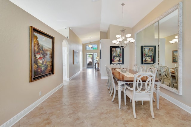 dining space with light tile patterned floors, a chandelier, and lofted ceiling