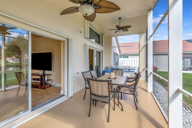 sunroom / solarium featuring ceiling fan