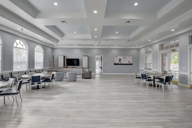 dining room with a raised ceiling and light hardwood / wood-style flooring