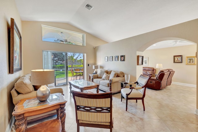 living room with ceiling fan, light tile patterned flooring, and lofted ceiling