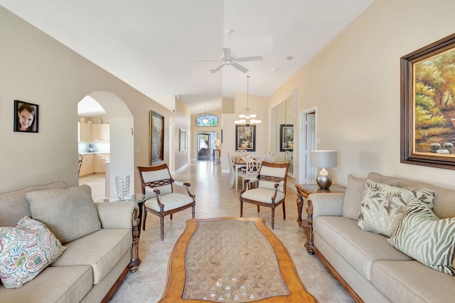 tiled living room with ceiling fan with notable chandelier and lofted ceiling