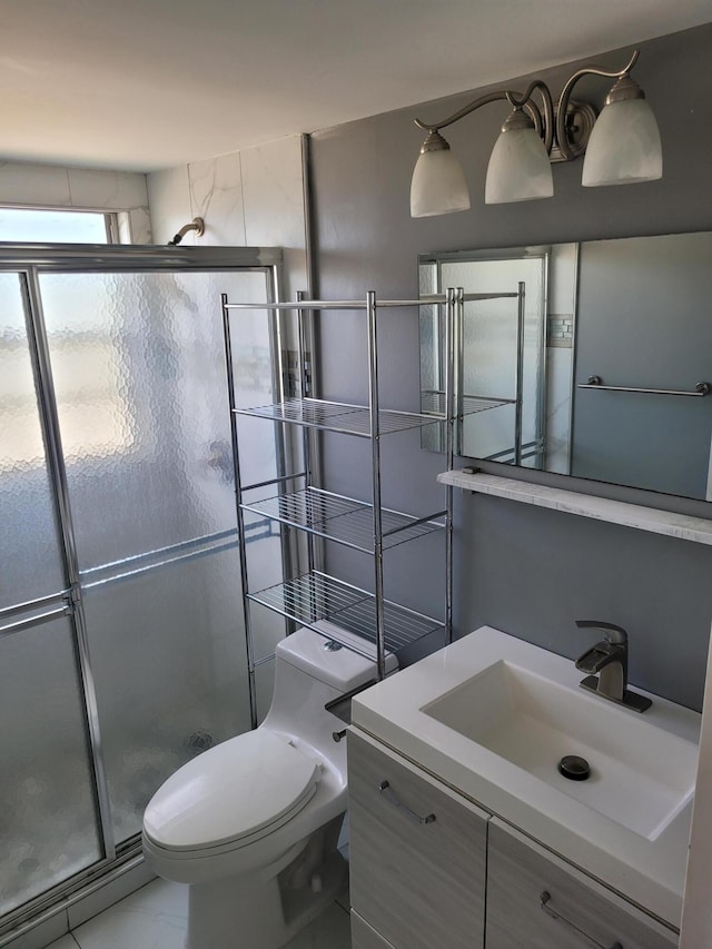 bathroom featuring tile patterned floors, vanity, an enclosed shower, and toilet