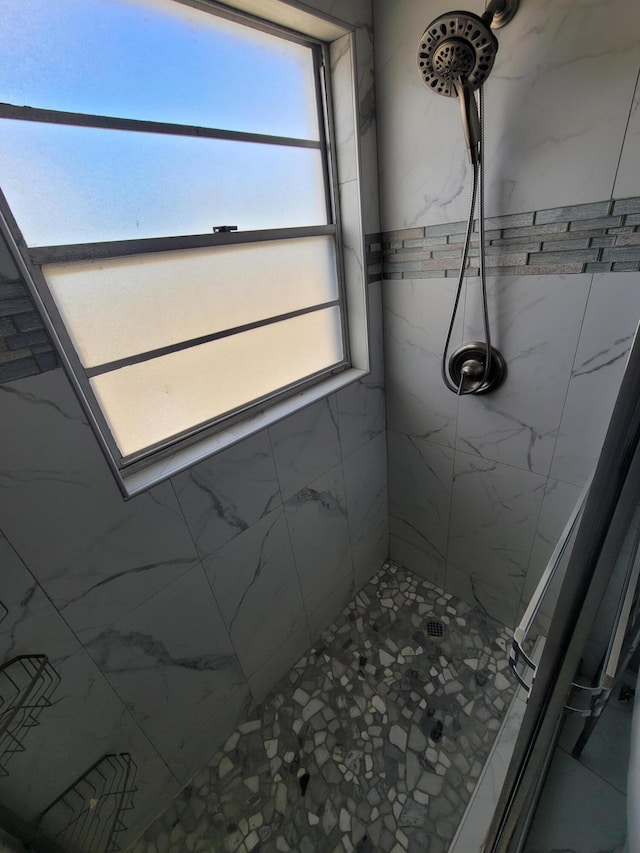 bathroom with tiled shower