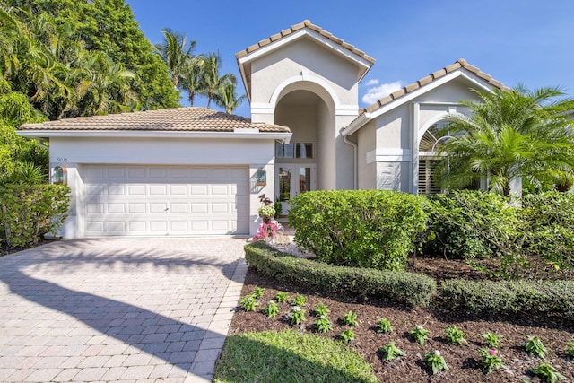 mediterranean / spanish home featuring a garage