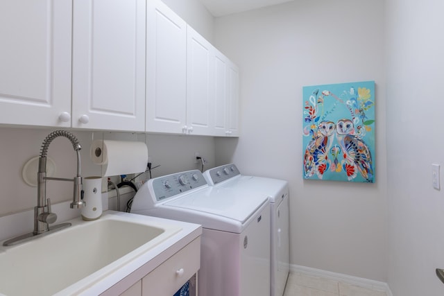 washroom featuring sink, cabinets, and washer and dryer