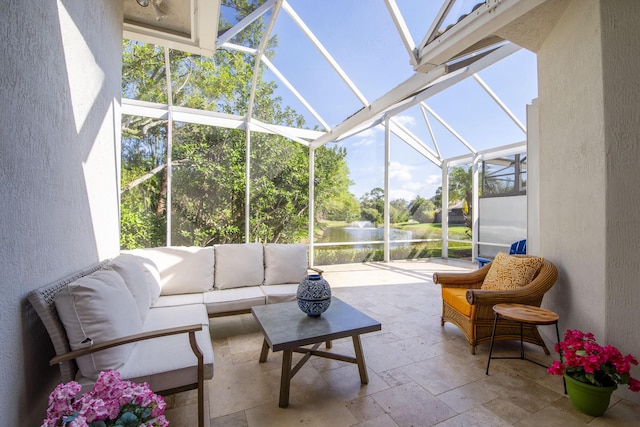 sunroom featuring a water view and an outdoor hangout area