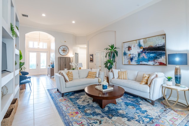 tiled living room featuring french doors and ornamental molding