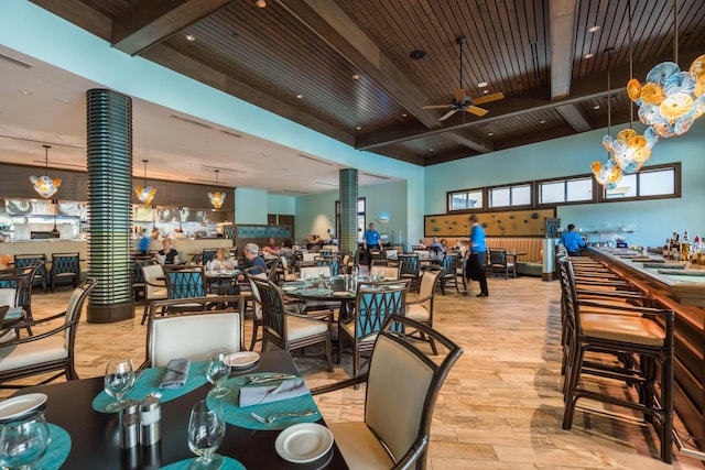 dining room with wooden ceiling, light hardwood / wood-style floors, beamed ceiling, and ceiling fan