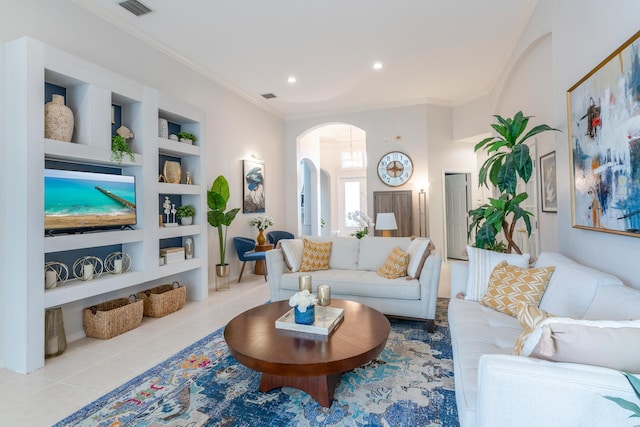 living room featuring built in features, light tile patterned flooring, and ornamental molding