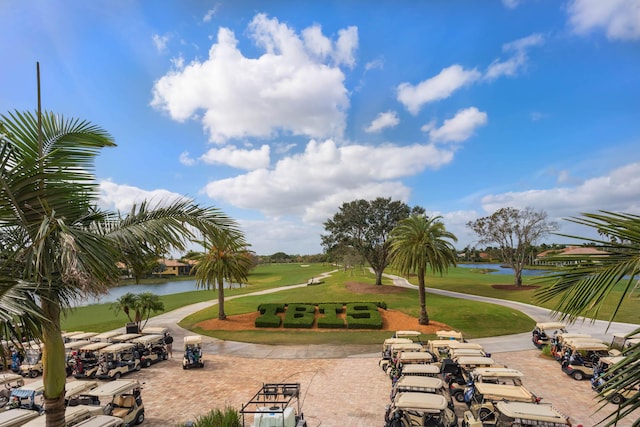 view of property's community featuring a water view and a yard