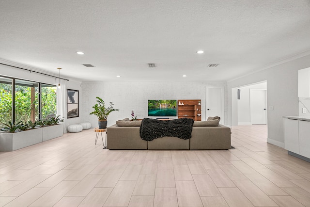 living room with light hardwood / wood-style floors and a textured ceiling