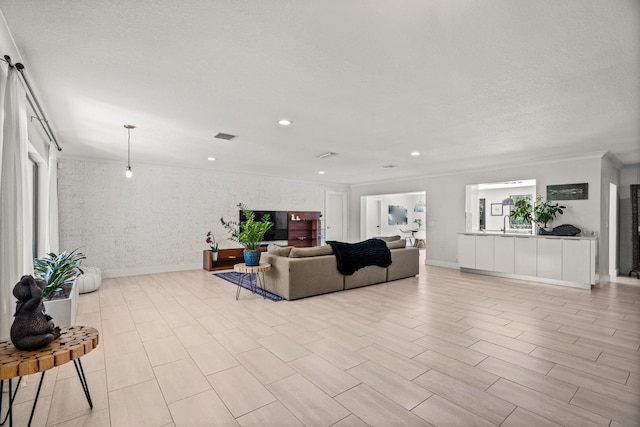 living room with light hardwood / wood-style floors and a textured ceiling