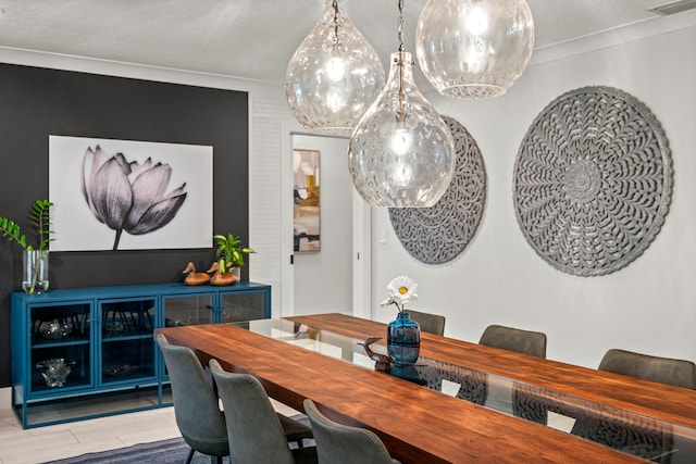 dining area featuring light hardwood / wood-style floors and crown molding