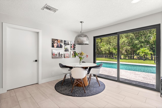 dining room with a textured ceiling