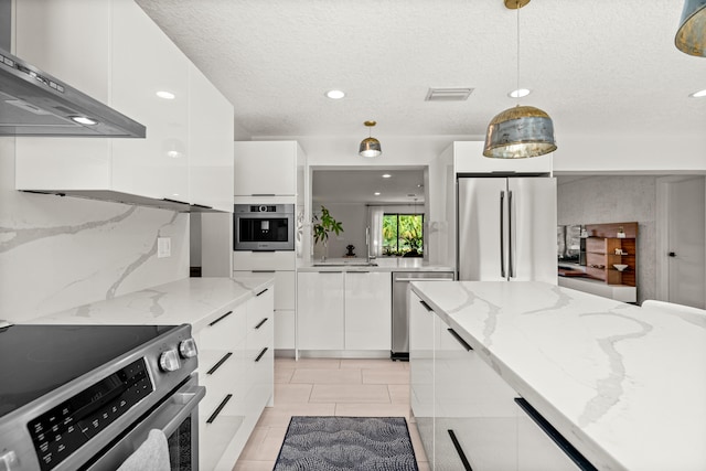 kitchen with white cabinets, decorative light fixtures, light stone countertops, and stainless steel appliances