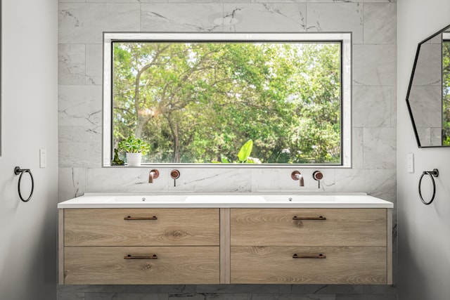 bathroom with vanity, tile walls, and a wealth of natural light