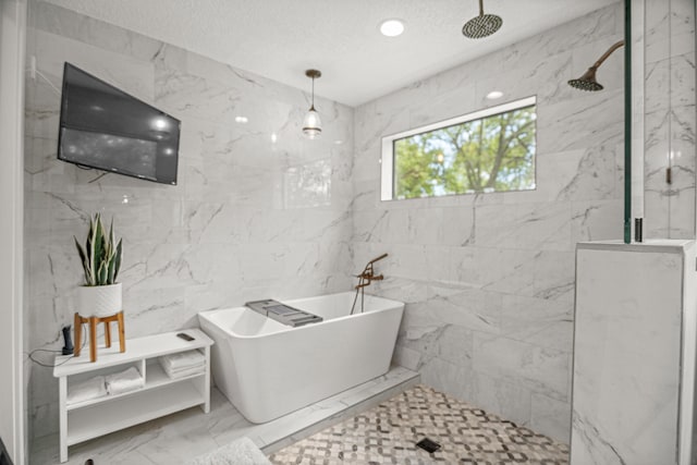 bathroom featuring a textured ceiling, tile walls, and independent shower and bath