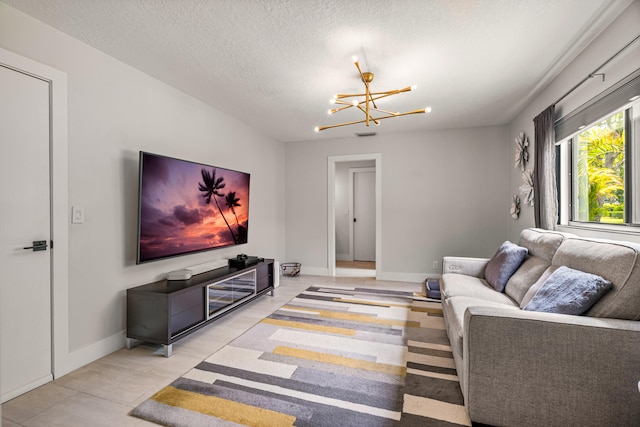 living room featuring light tile patterned floors, a textured ceiling, and an inviting chandelier