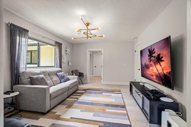 living room featuring a notable chandelier and a textured ceiling