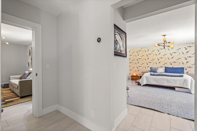 hall featuring light hardwood / wood-style flooring and a notable chandelier