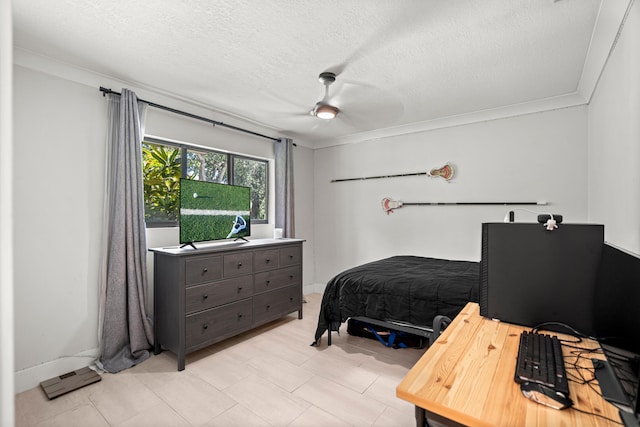 bedroom featuring ceiling fan, crown molding, and a textured ceiling