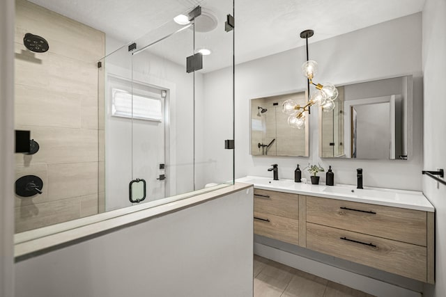 bathroom featuring vanity and a shower with door