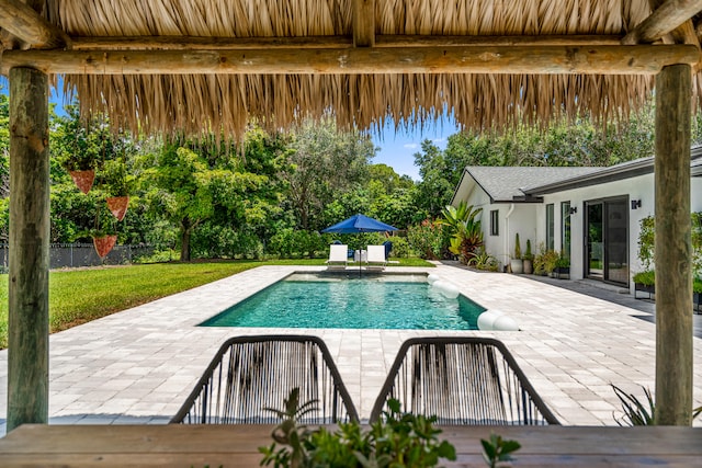 view of pool featuring a lawn and a patio area