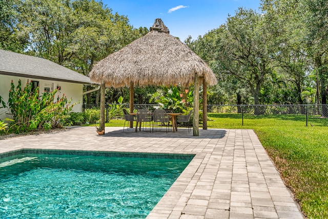 view of pool featuring a patio area and a yard