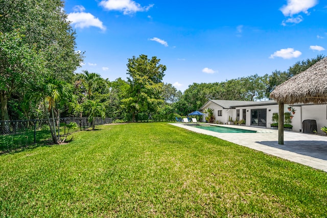 view of yard featuring a fenced in pool and a patio area